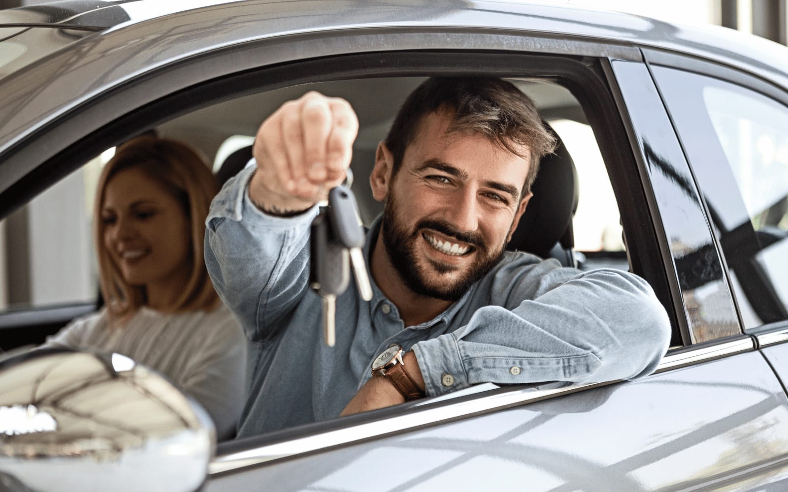 Driver holding keys beside a vehicle